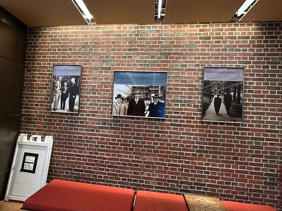 Economics legends display inside front vestibule of Saieh Hall